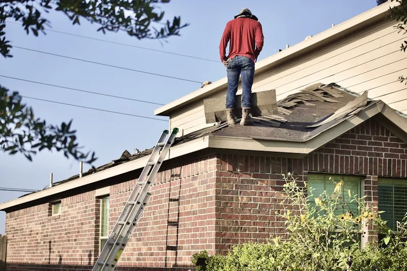 Professional roofer working on a residential roof in Avalon Harbor